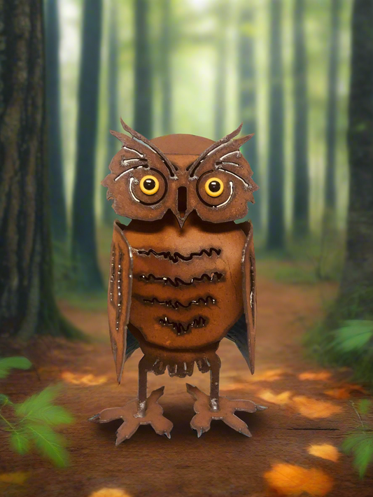 Metallic owl sculpture in a forest setting