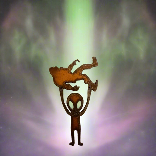 Alien Holding Bigfoot Rustic Metal Magnet
