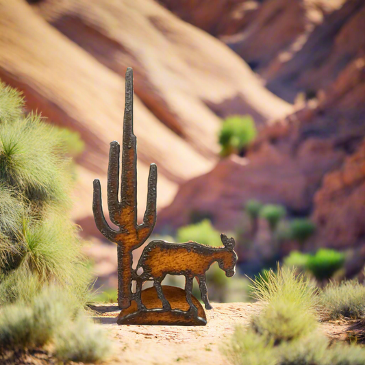 A rustic metal figurine of a donkey with a cactus doodad, created from recycled American steel, with a natural rust patina finish.