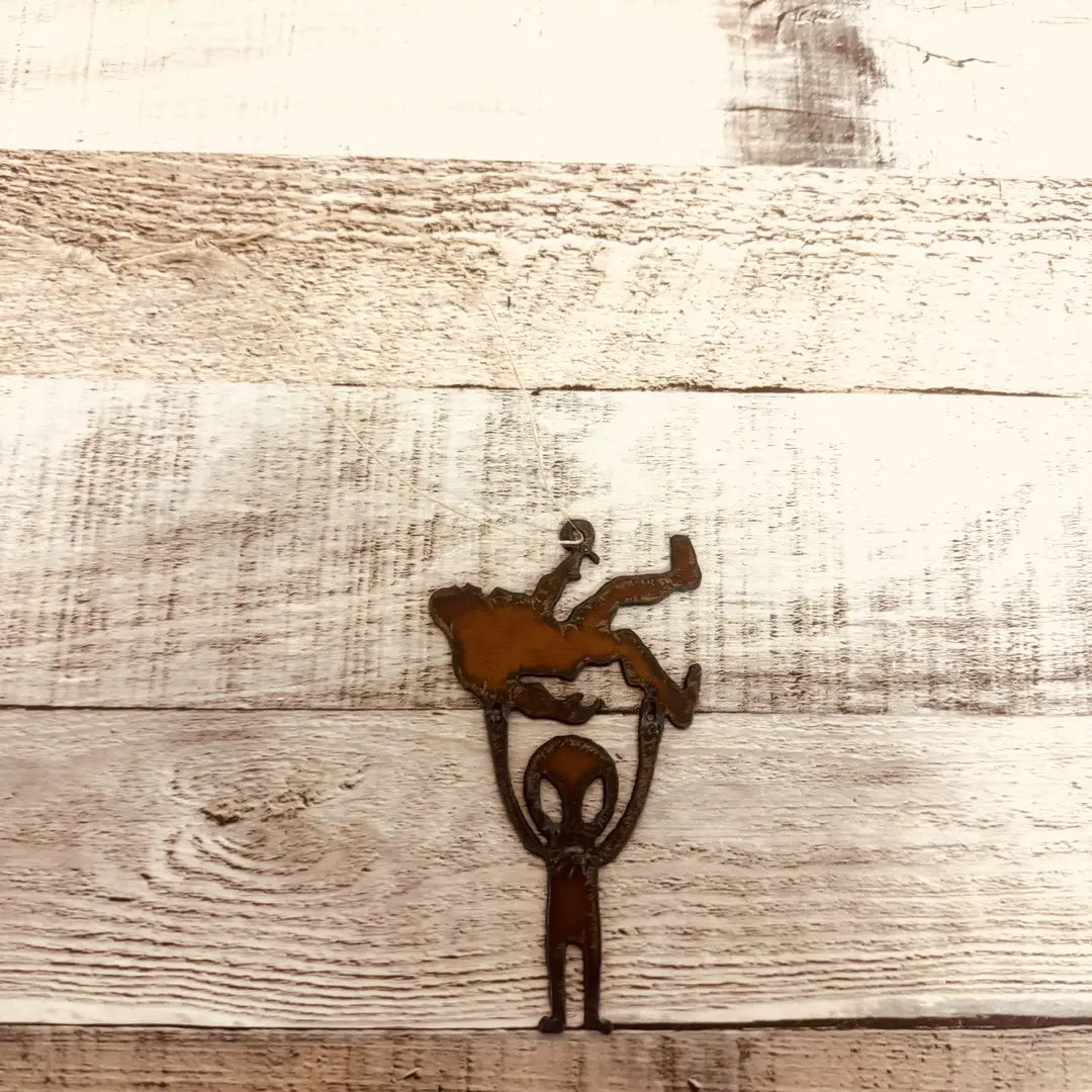 Alien Holding Bigfoot Rustic Metal Ornament